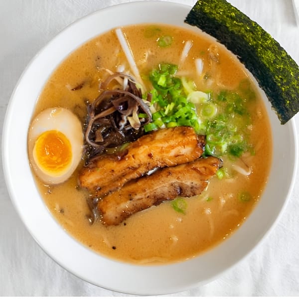 Motto Ramen's tonkotsu ramen with pork belly, soft-boiled egg, green onions, and seaweed.